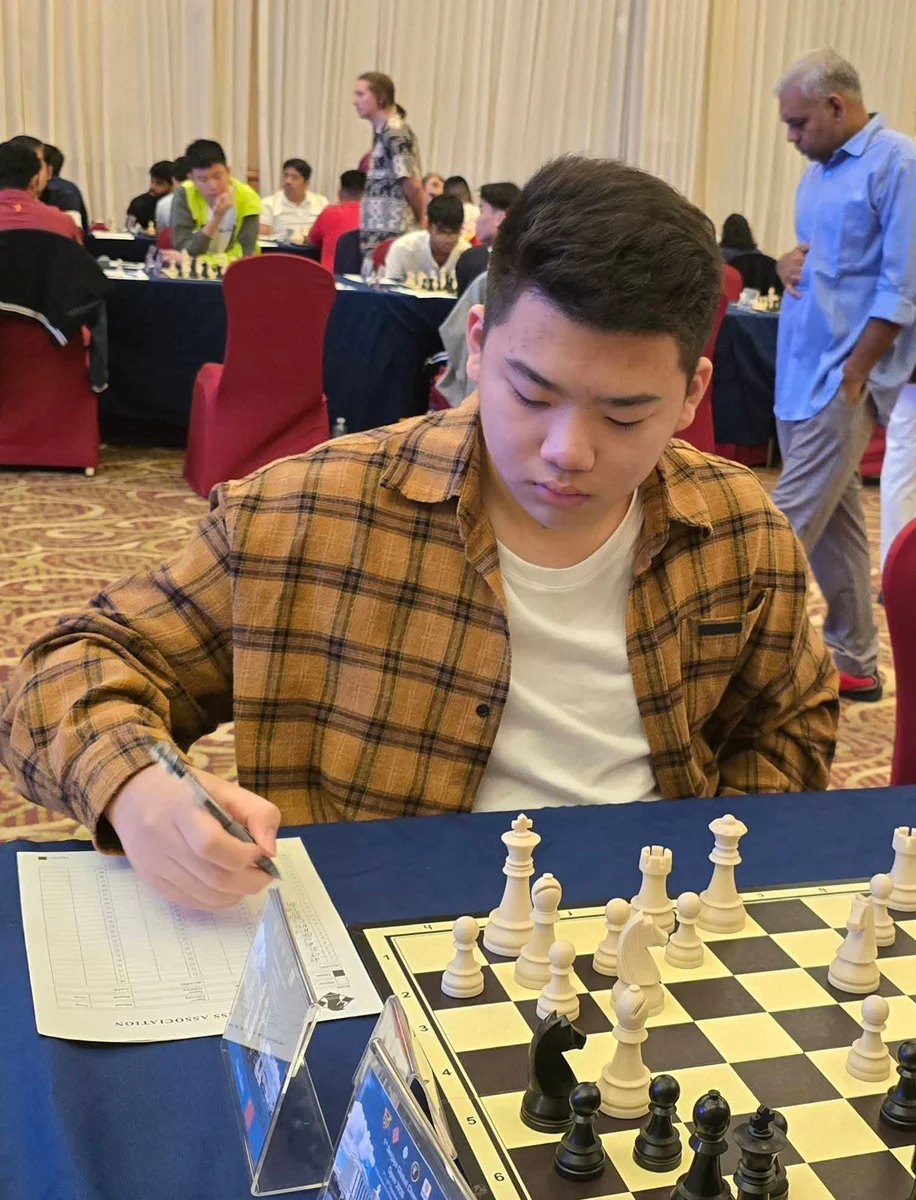 Young player studying the board at the 1st Berjaya Global Chess Open 2026